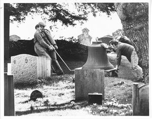 St John the Baptist Church, Wolverley. Church bells, which had been removed for renovation in October, had finally been rehung in the church tower. The photograph shows bell-hangers wheeling one of the bells through the churchyard on February 25, 1988.