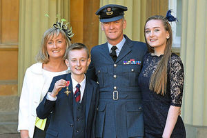 Wing Commander Michael Formby with his wife Julie, daughter Phoebe, and son Will at the Palace