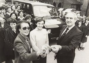 The parent teachers association at Queen Mary's High School, Walsall, raised money for a minibus for sporting fixtures and outside lessons. The photograph shows Robin Bond handing the keys to Valery Reid, with Kerry Smith in the centre, in September 1982.