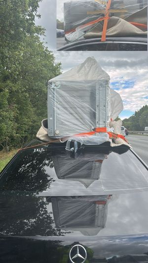 Freeze! Motorist who strapped fridge-freezer to roof stopped by police