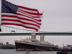 The SS United States being towed down the Delaware River