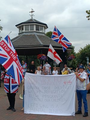 Protestors with 'refugees not welcome' sign in Cannock
