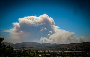 A cloud of smoke from a forest fire rises over the island of Rhodes on Saturday. Photo: Argyris Mantikos/Eurokinissi via AP.