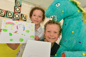 Brother and sister Ben and Iris Nankervis with their paintings