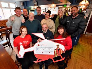 Steve Flavell (centre) with Candice and Kay Starkey from Air Ambulance, and people from local businesses who raised money for the charity. They are pictured at The Old Bush Inn, Bradley Lane, Bilston.