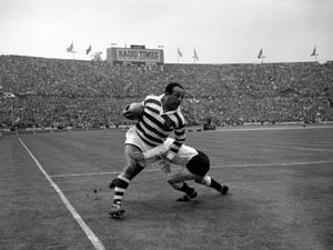 Billy Boston (Wigan) bursts through despite a tackle by I Watts (Hull) during the rugby league Challenge Cup final at Wembley in 1959