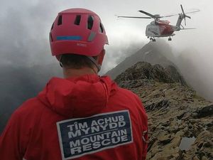Supporting image for story: Stunning pictures capture moment climbers plucked to safety from cloud-covered peak 