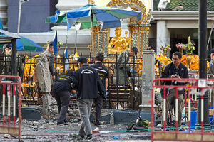 Police investigate the scene after the explosion at the Hindu shrine in Bangkok