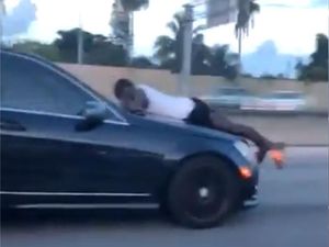 Supporting image for story: Police release 911 call made by man on bonnet of car driving at 70mph