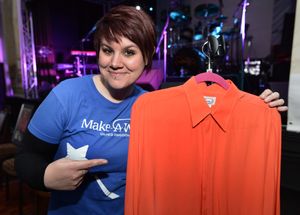 Nikki Wrench from the Make a Wish charity with one of Rod Stewart's shirts