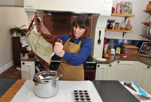 Rebecca McQuilkin who runs chocolicious making homemade chocolates.  Pouring the chocolate chips ahead of melting
