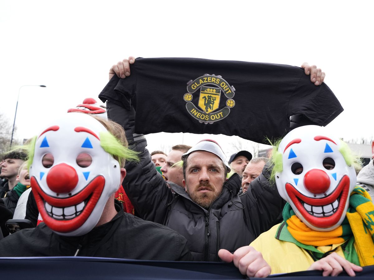 Man Utd supporters wear clown masks in protest ahead of Fulham match