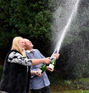 The couple celebrate with a bottle of bubbly today