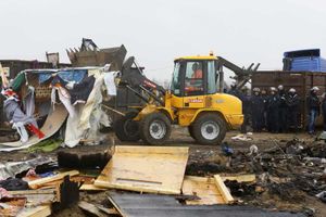 A bulldozer clears part of the Calais migrant camp, known as the Jungle, in March