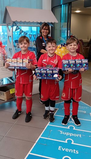 Reggie, Ethan, Frankie and Manager Nikki delivering goodies