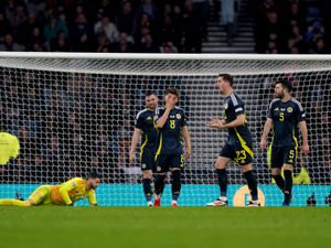 Scotland players look at each other after conceding a third goal against Greece