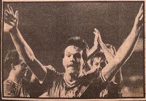 Peter Hart raises his arms to celebrate with the 2,000 travelling fans.