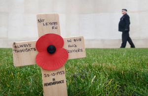 A man pays his respects at the National Memorial Arboretum in Alrewas, Staffordshire