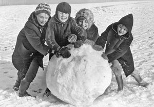 Taking a last chance to make the biggest snowball in Sandwell, before going back to school after the holidays, are (from left) Ruth Phillips, aged 11 years, Paul Dyke, aged seven years, Julie Dyke, aged ten years, and Rachael Phillips, aged nine years, pictured in January 1977