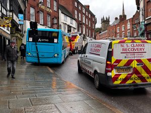The road sign was bent after being hit by the bus