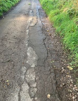 The surface of the road is badly worn away