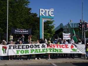 People attend a pro-Palestine protest outside RTE in Dublin