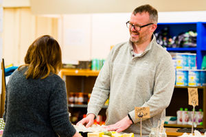 Founder volunteer Simon Calaby with a customer.