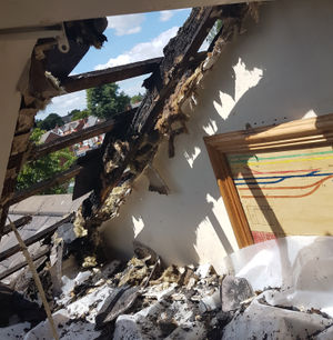 Damage to the roof of the house the fire spread to. Photo: Ste Jones