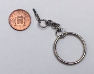 What is believed to be the world's smallest pocket penknife, next to a penny.