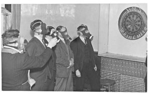 Gas masks were worn by the players at the Spring Hill Inn, Penn, and the local ARP post in a darts match for the Express and Star Comfots Fund. Date stamp 21 April 1942
