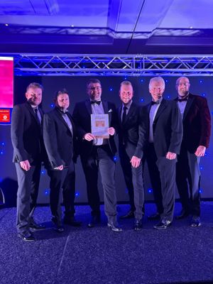 Sam Hill (centre) accepts the award on behalf of the 3 Hammers' Team