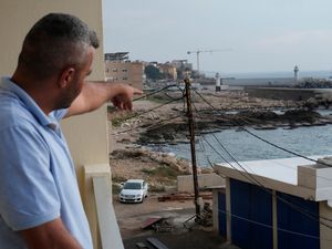 A man points to a beach