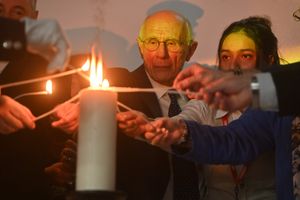 Symbolic lighting of the candle of remembrance.
