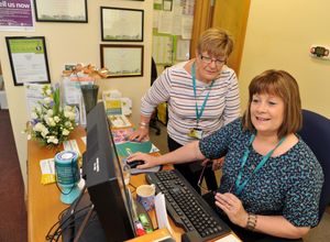 Receptionist Debbie Bradford coordinating with volunteer Virginia Johnson
