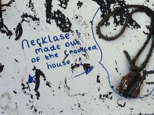 Supporting image for story: 'Necklaces made out of The Crooked House' – Shrine set up amid rubble at site of arson-hit and demolished pub