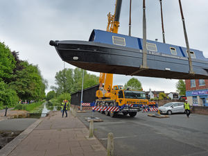 Supporting image for story: Dazzling narrowboat takes to the water on Newport Canal with aid of large crane