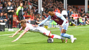 Walsall's.Tom Knowles goes down under pressure from Villa's Aaron Ramsey.