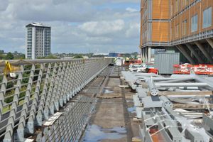 A walkway high on the site covered with building materials