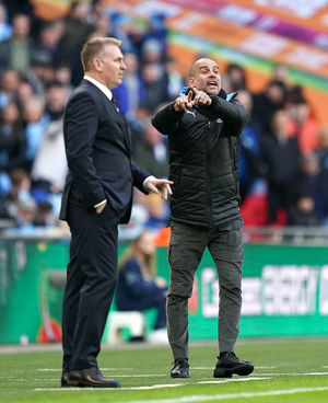 Manchester City manager Pep Guardiola (right) and Aston Villa manager Dean Smith on the touchline