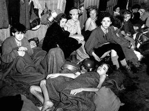 Women and children, some of over 40,000 concentration camp inmates liberated by the British, suffering from typhus, starvation and dysentary, huddle together in a barrack at Bergen-Belsen