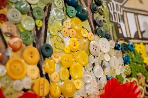 The mural is made up of buttons and features local scenes as well as wartime vehicles