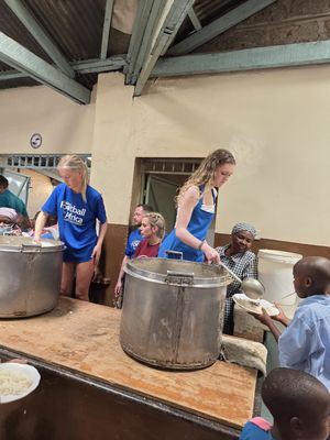 Anna Gwilt and Grace James helping serve lunch to 900 children at St Martin's School Kibagare Good News Centre in Nairobi.