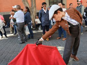 A young supporter of bullfighting with a red flag