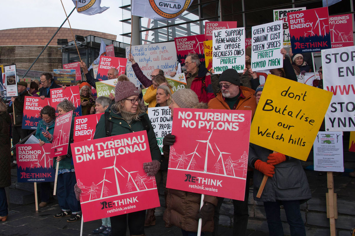 Protesters from across Wales descended on the Senedd to take part in a demonstration against plans to build some of the UK’s tallest turbines near to rural communities