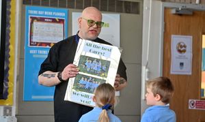 Pupils present Garry with cards wishing him the best in his retirement.