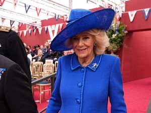 Queen Camilla arrives for the military procession for the 80th anniversary of VE Day, in honour of those who served during the Second World War, at Buckingham Palace in central London