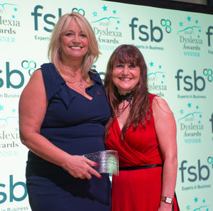 Deborah Mitchell, left, receives the entrepreneur award fromi Lindsay Barton of the Federation of Small Businesses