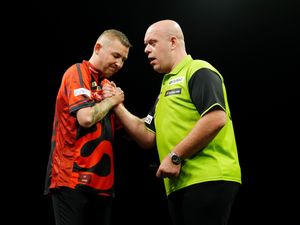 Nathan Aspinall, left, and Michael van Gerwen on stage