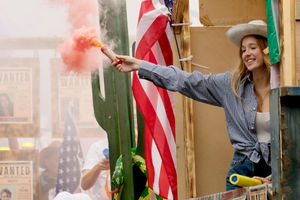 The Lakeside Boathouse cowboys used colourful flares to add to the party atmosphere while other sprayed water and threw sweets for children from the floats. Image by Andy Compton