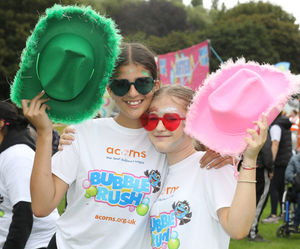 Gracie Mann and Isabella Boswell with their cowboy hats at the Acorns Bubble Rush.